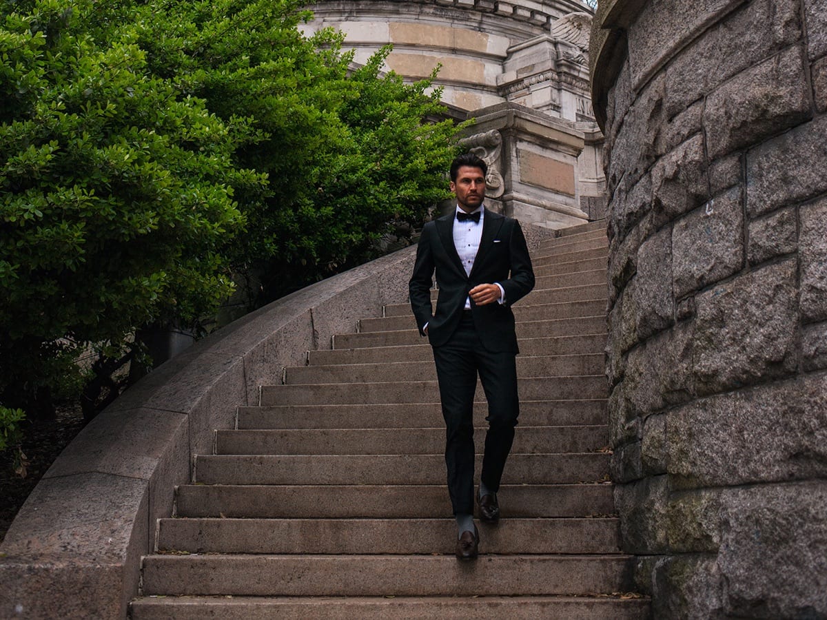 Man descending outdoor stairs wearing tuxedo