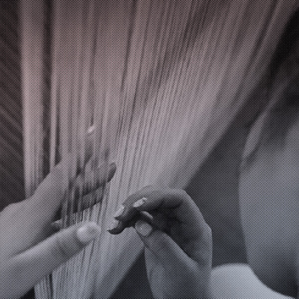 Person inspecting a fabric loom