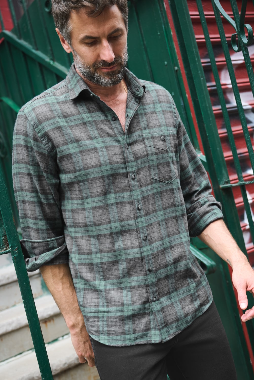 Man descending stairs in casual flannel shirt