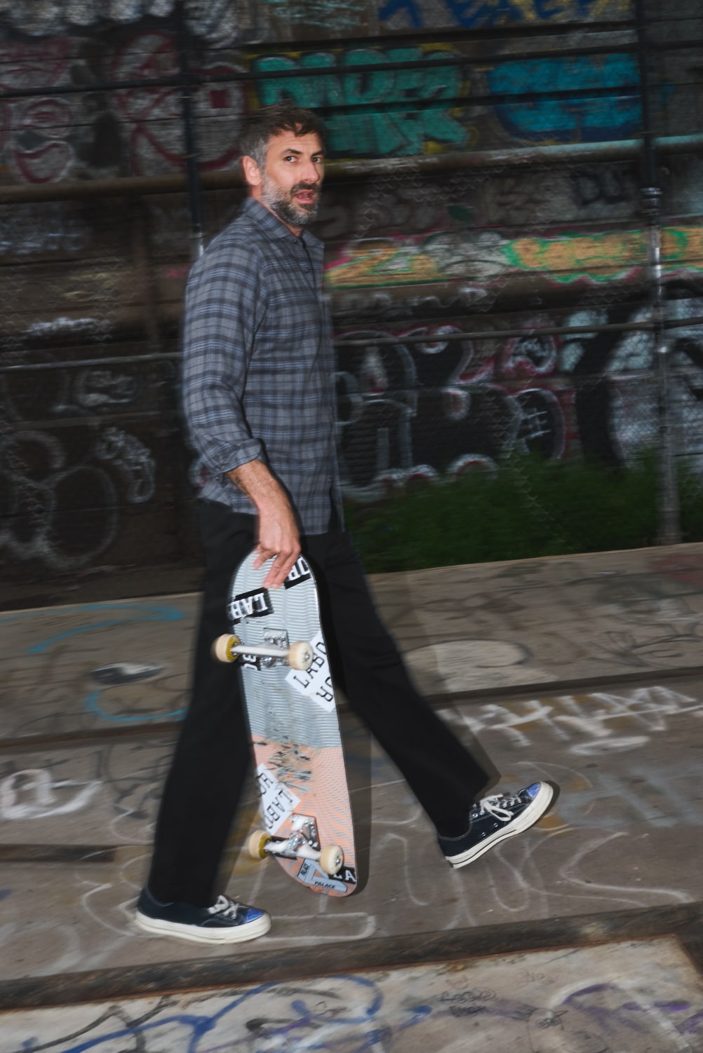 Man at skatepark wearing Slate and Charcoal shirt