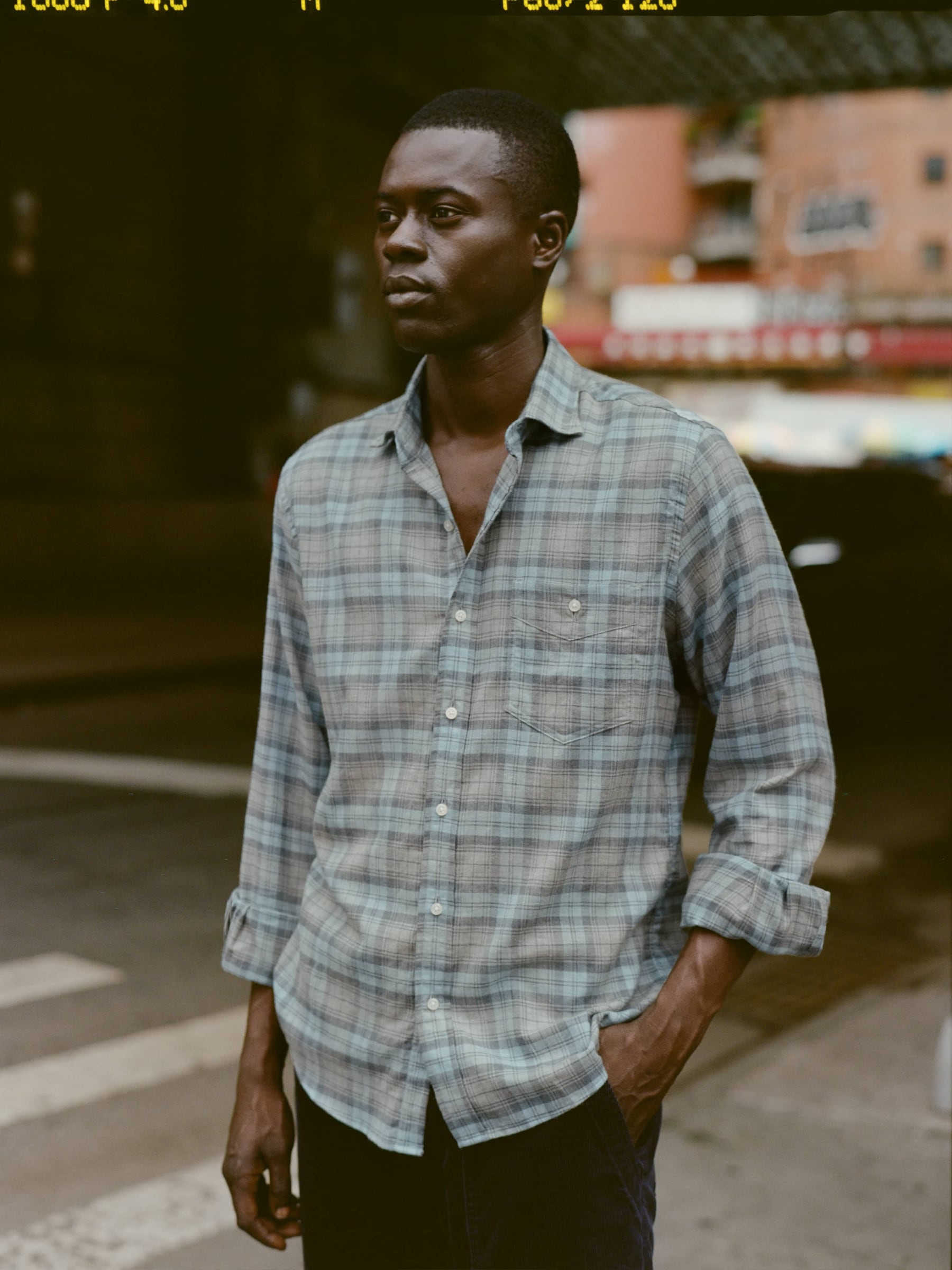 Man under bridge in a slate and sky colored shirt