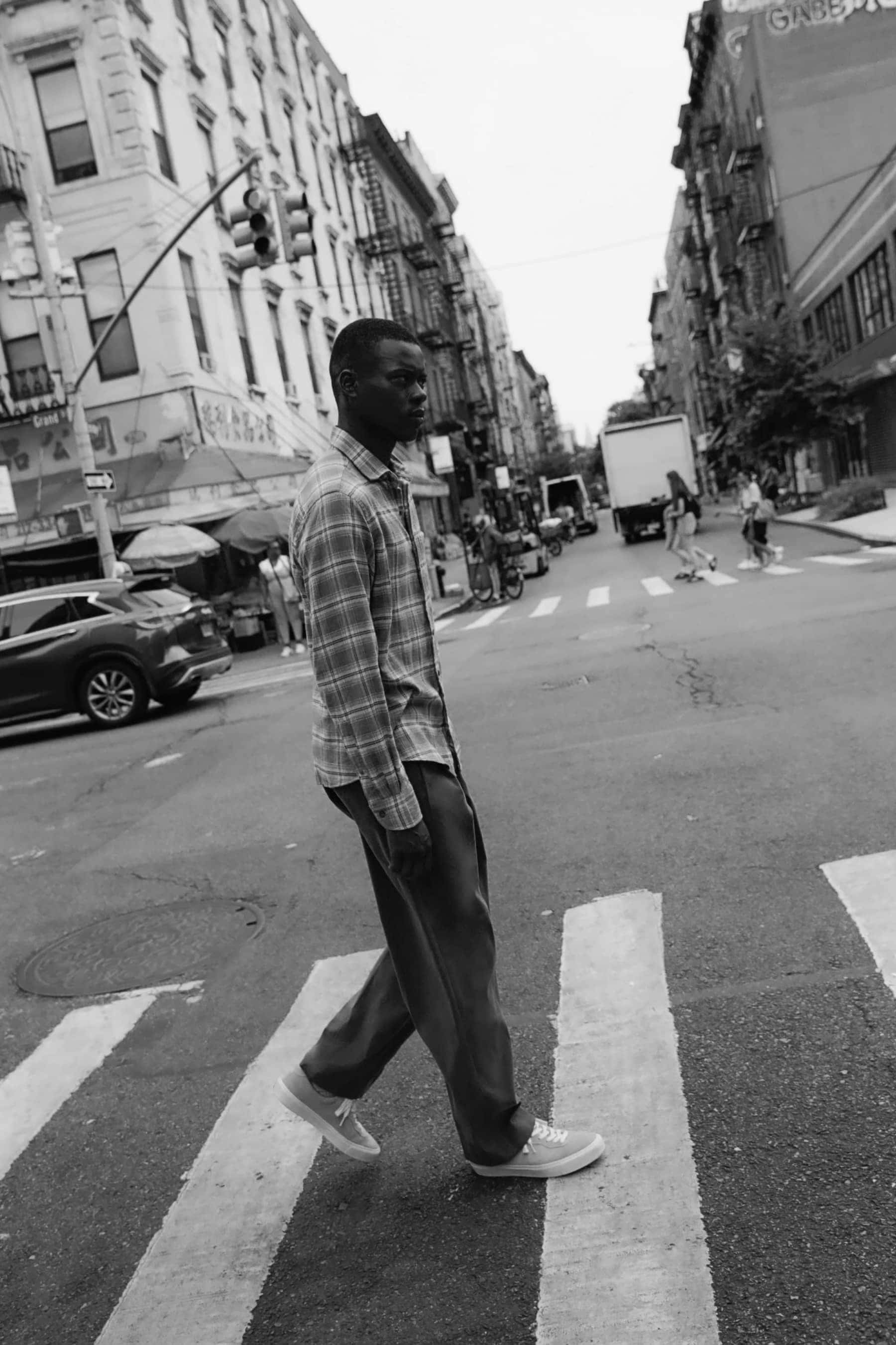 Man walking across street in plaid shirt 3