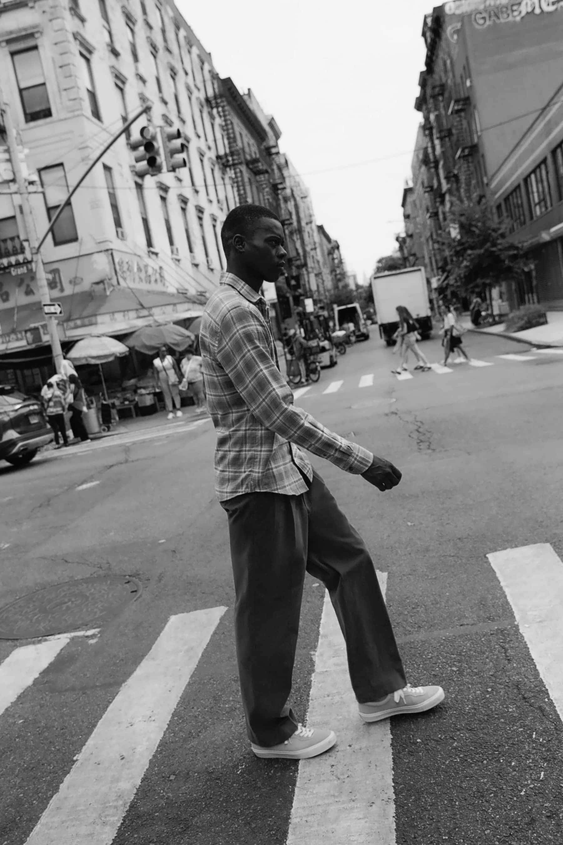 Man walking across street in plaid shirt 4