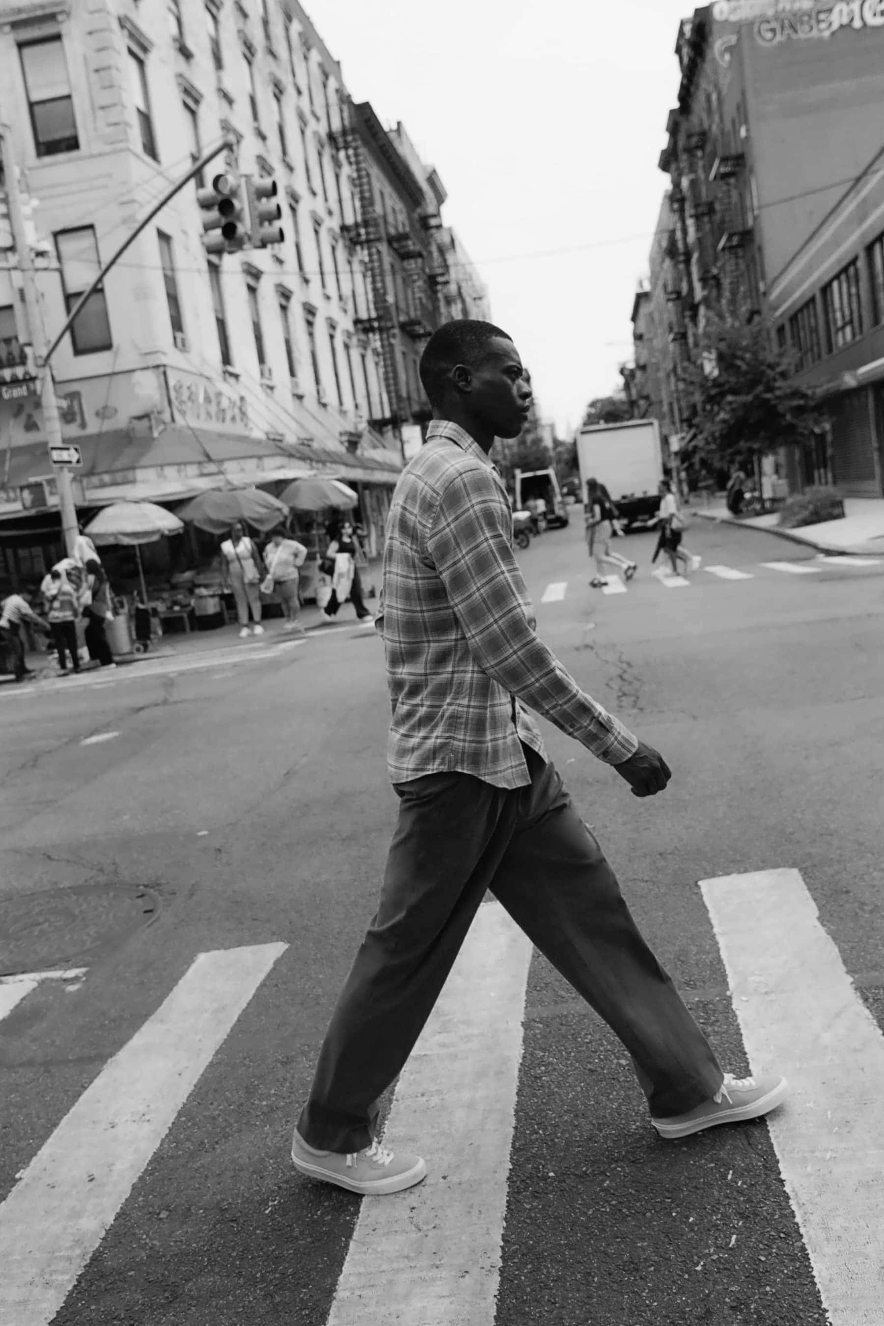 Man walking across street in plaid shirt 5