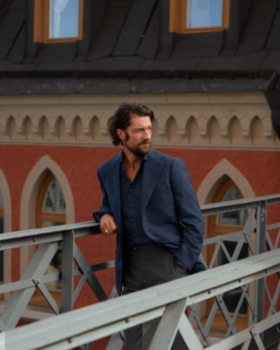 Man wearing Jacket and Shirt on bridge in Stockholm