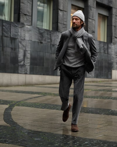 Man wearing suit walking on rainy street