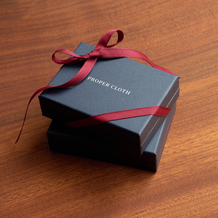 Proper Cloth gift card box, wrapped in ribbon.