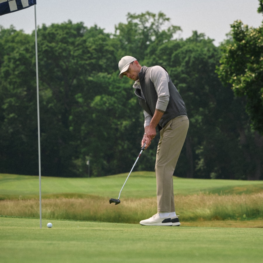 Man wearing custom golf clothing on a golf course.