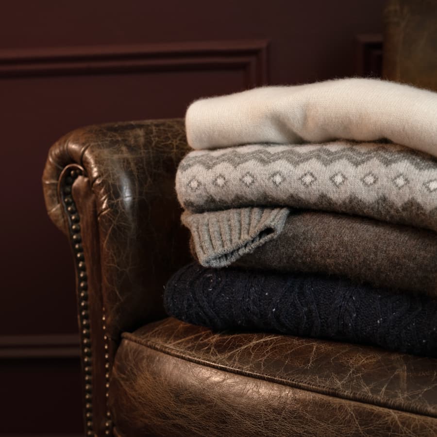 Bundle of soft, colorful sweaters showing a variety of textures.