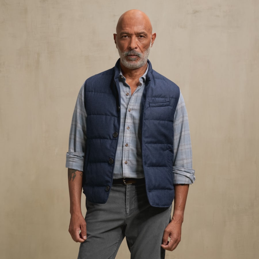 Man wearing a vest and flannel shirt