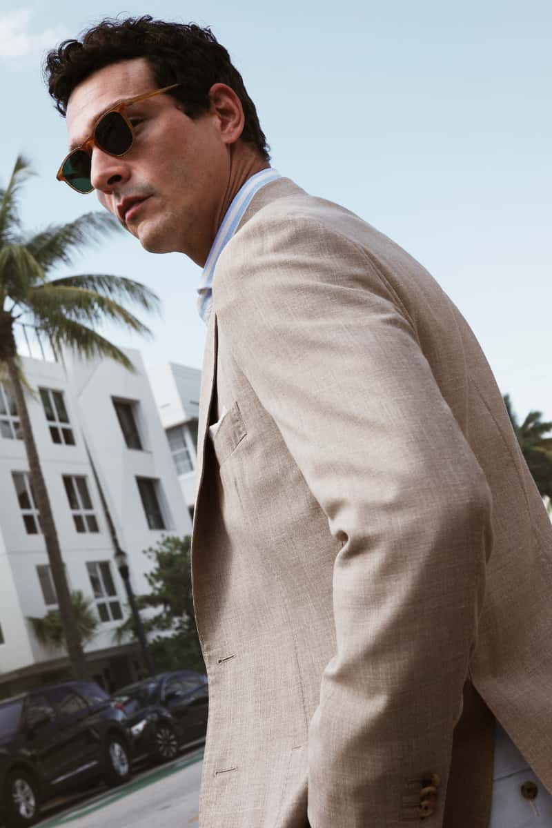 Man wearing a sport coat layered over a knit polo.