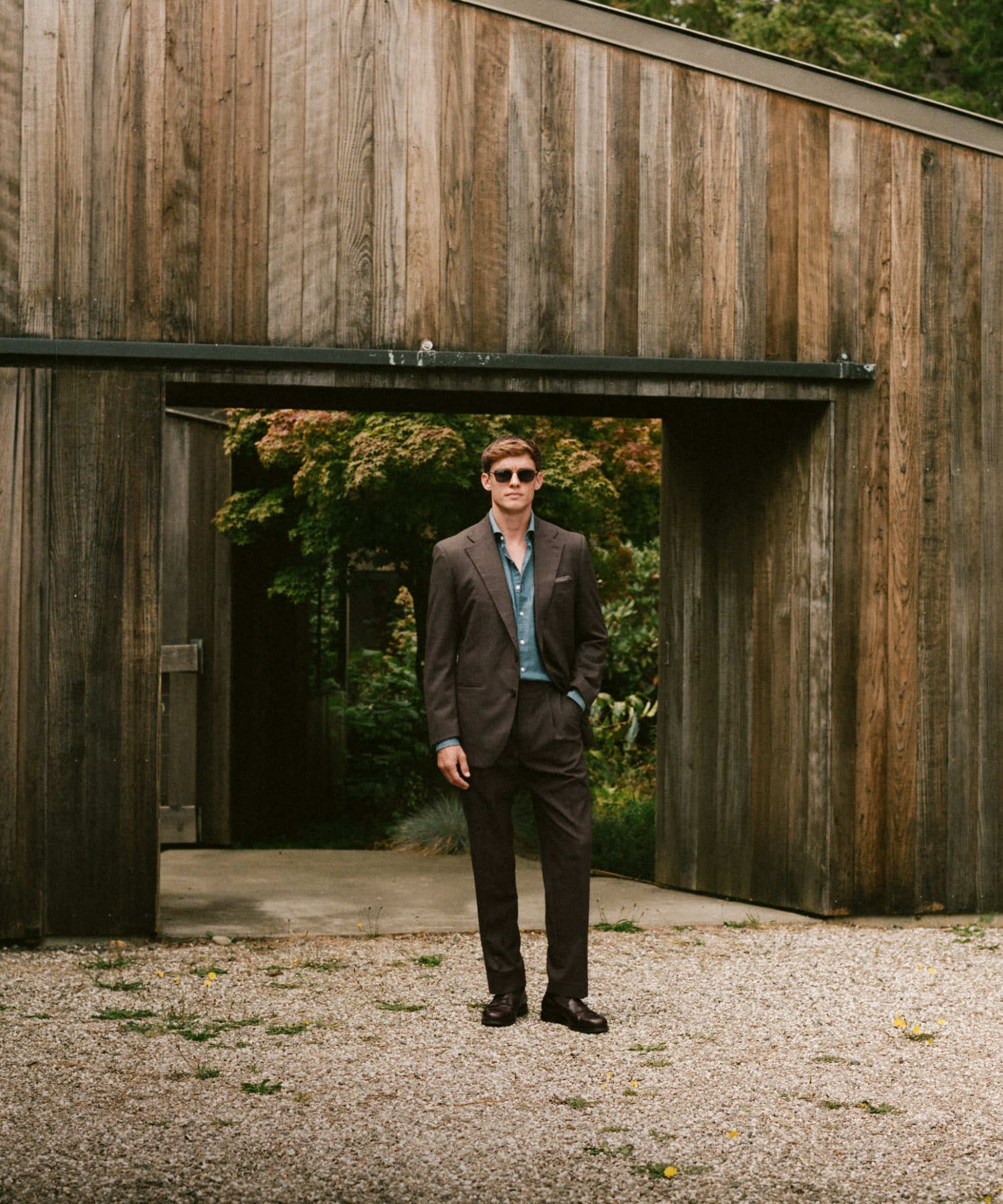 Man wearing a summer, linen suit, standing next to vintage car