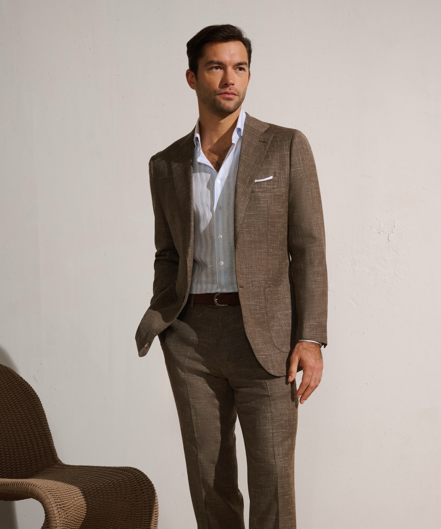 Man wearing a classic navy suit, paired with a tie and dress shirt