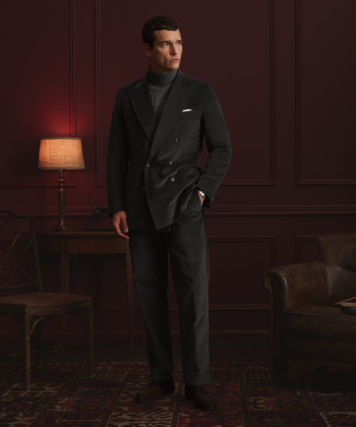 Man wearing a classic navy suit, paired with a tie and dress shirt